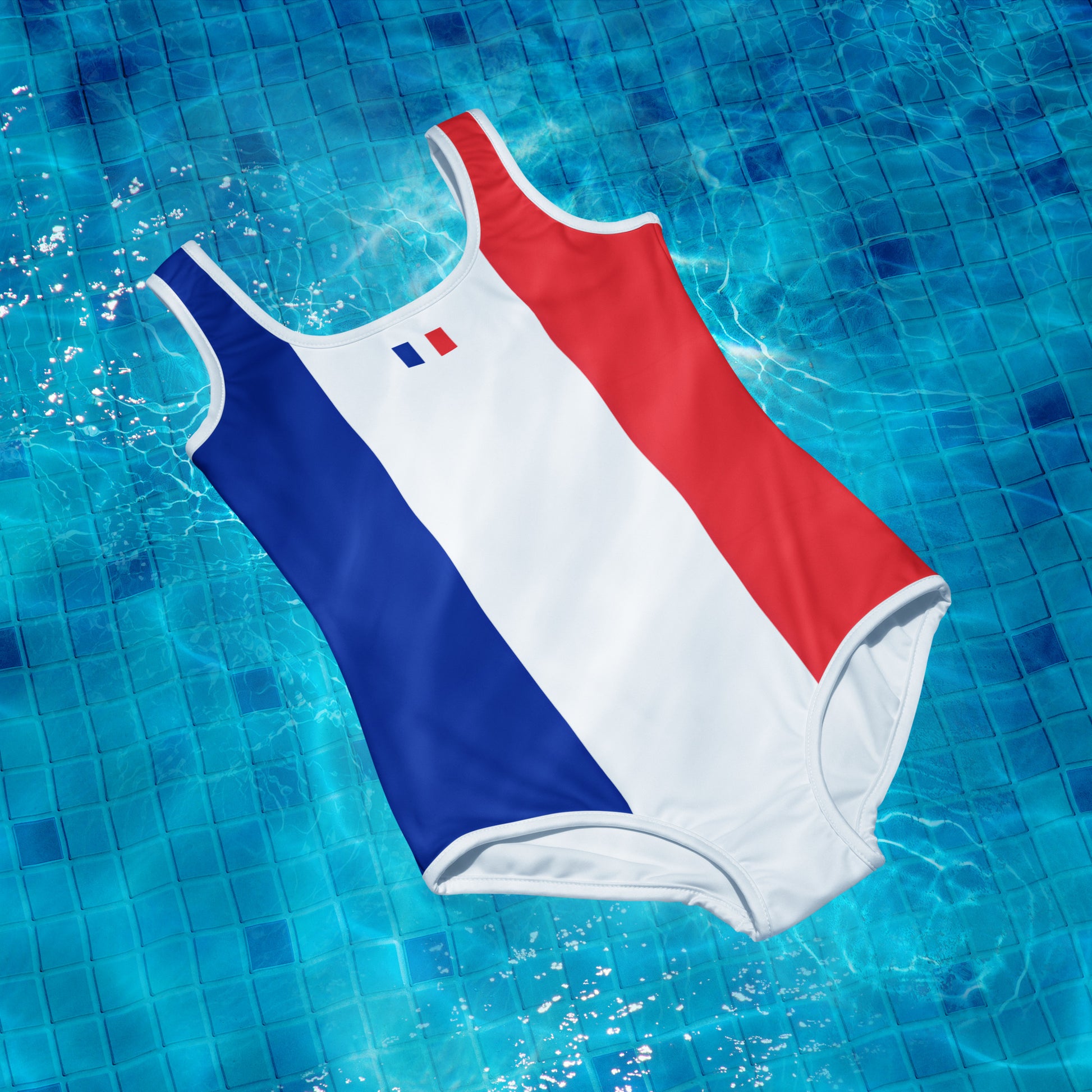 [Brand] swimsuit with French flag colors floating in pool.