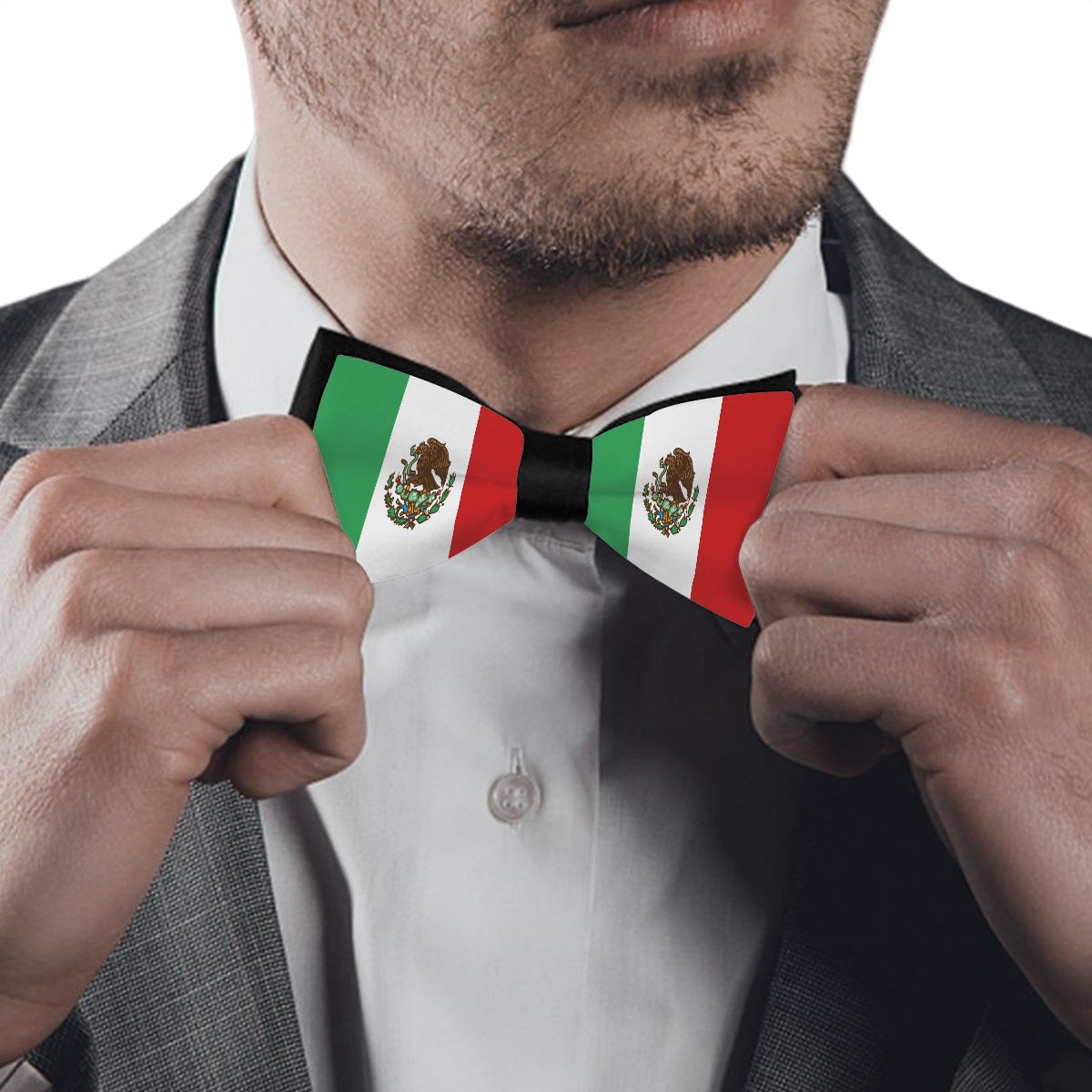 Man adjusting [Brand] Mexican flag bow tie, wearing suit.