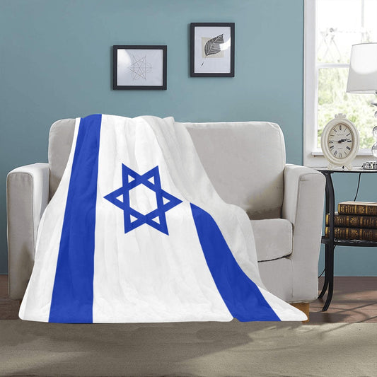 Cozy blanket on sofa featuring Israeli flag design, Luv My Flag.