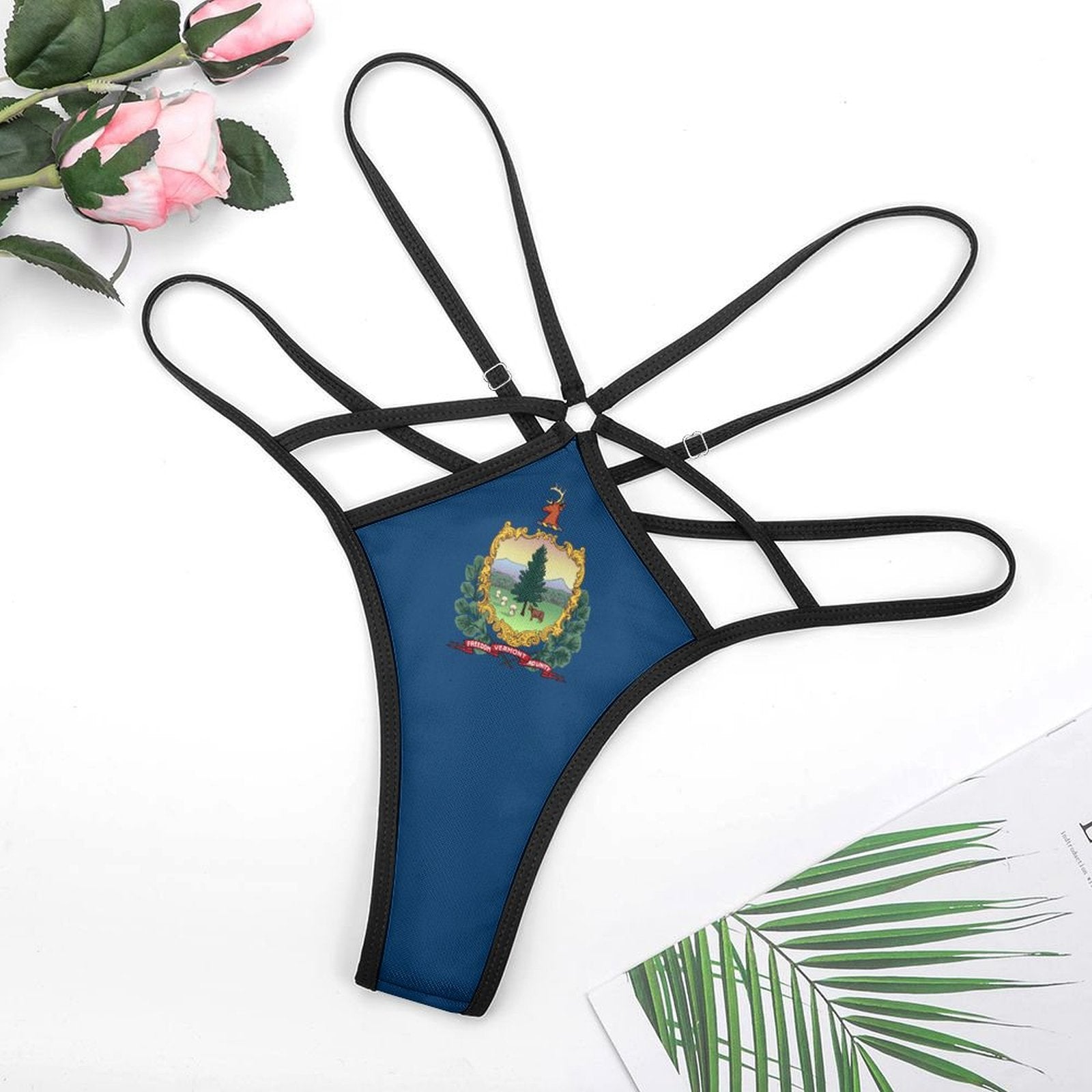 Blue thong with state emblem, black straps, [Brand]. Roses nearby.
