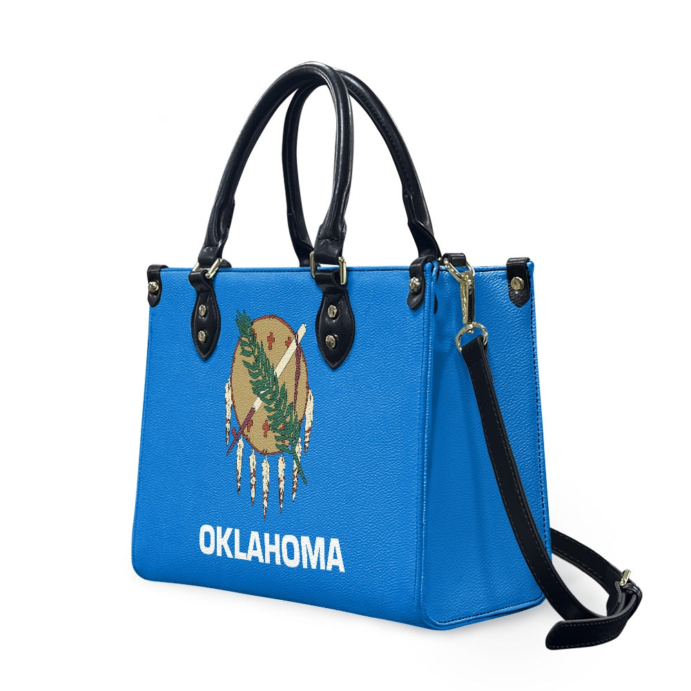 Blue [Brand] handbag with Oklahoma flag design and strap.