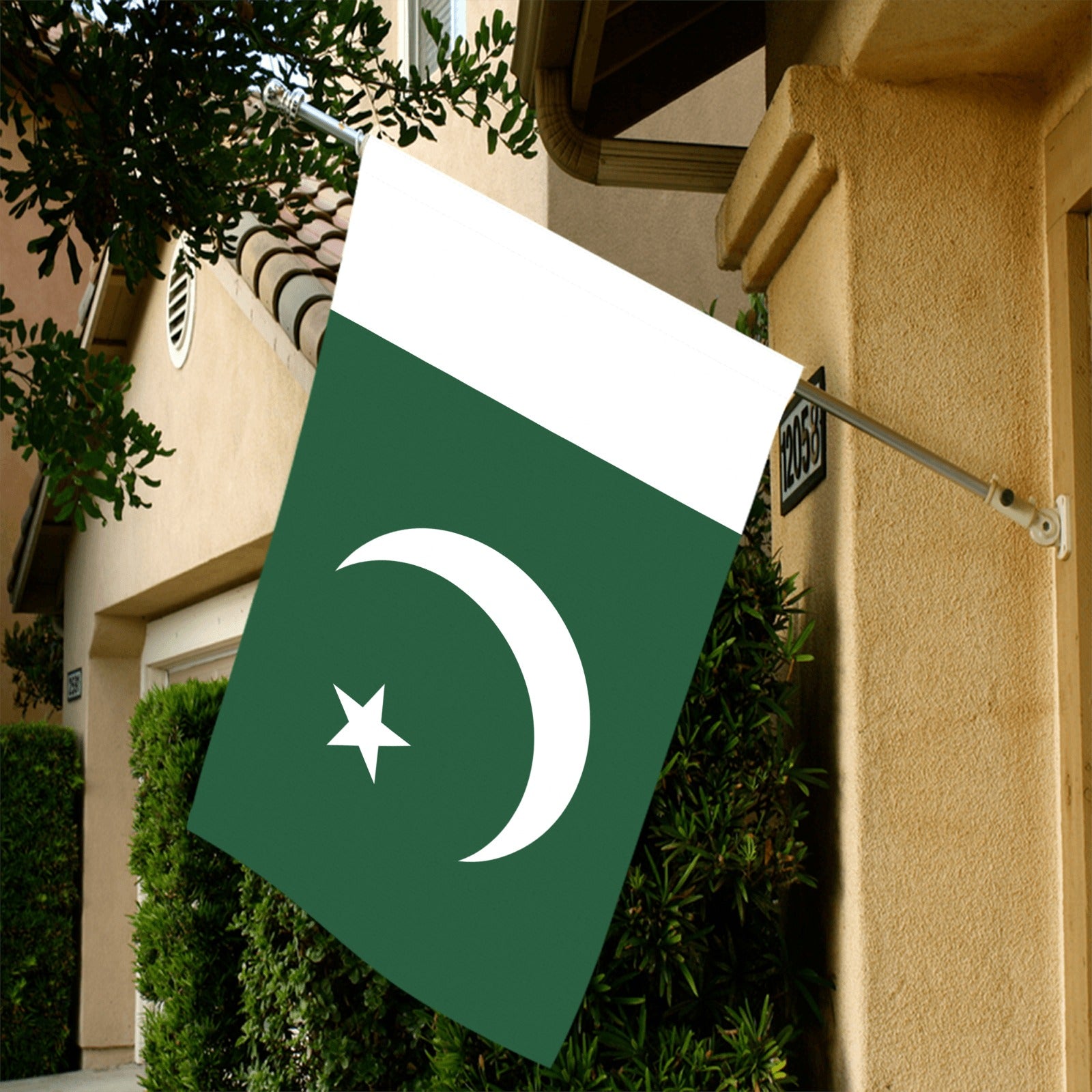 Hanging Pakistan flag by Luv My Flag, outside house.