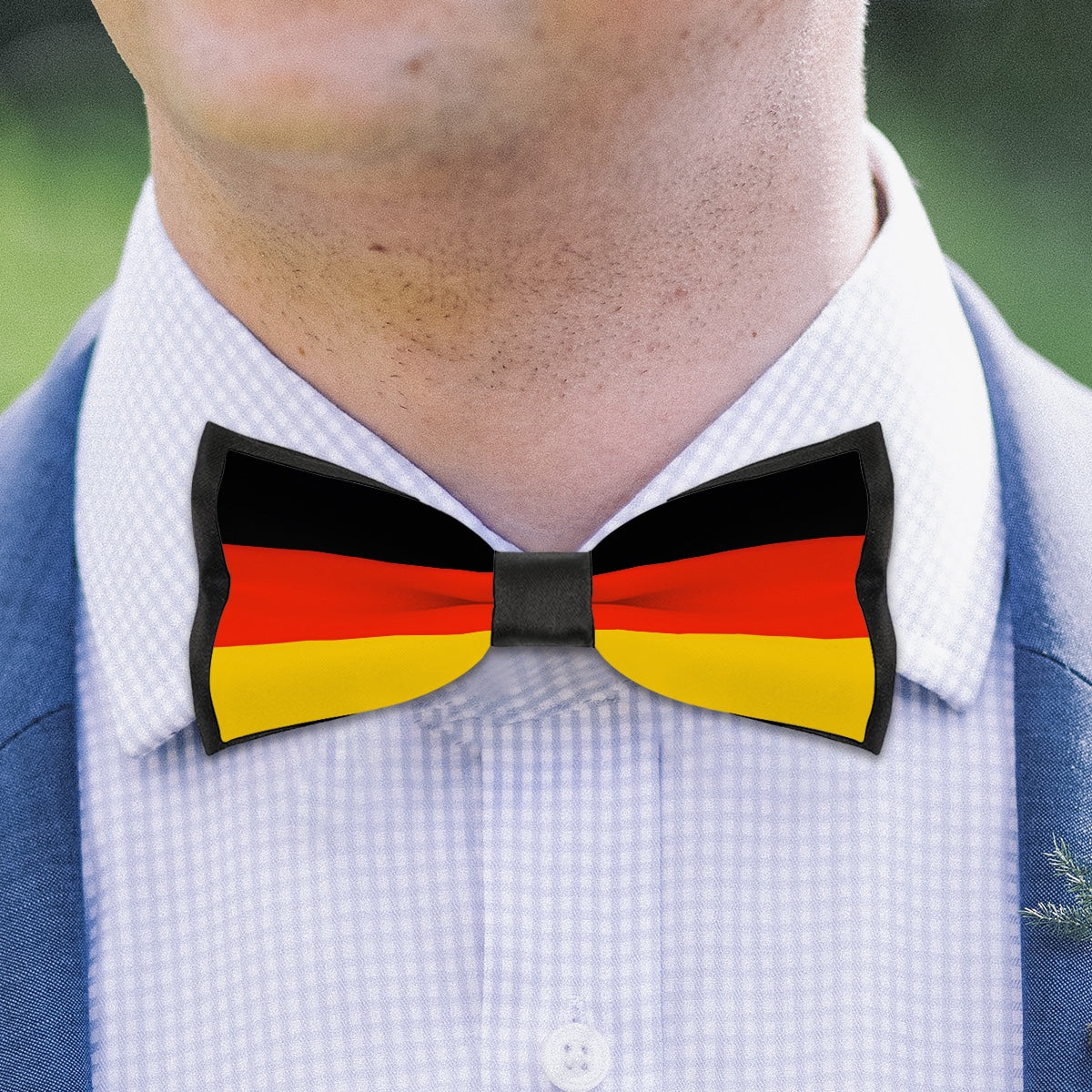 Man wearing [Brand] bow tie with German flag design.