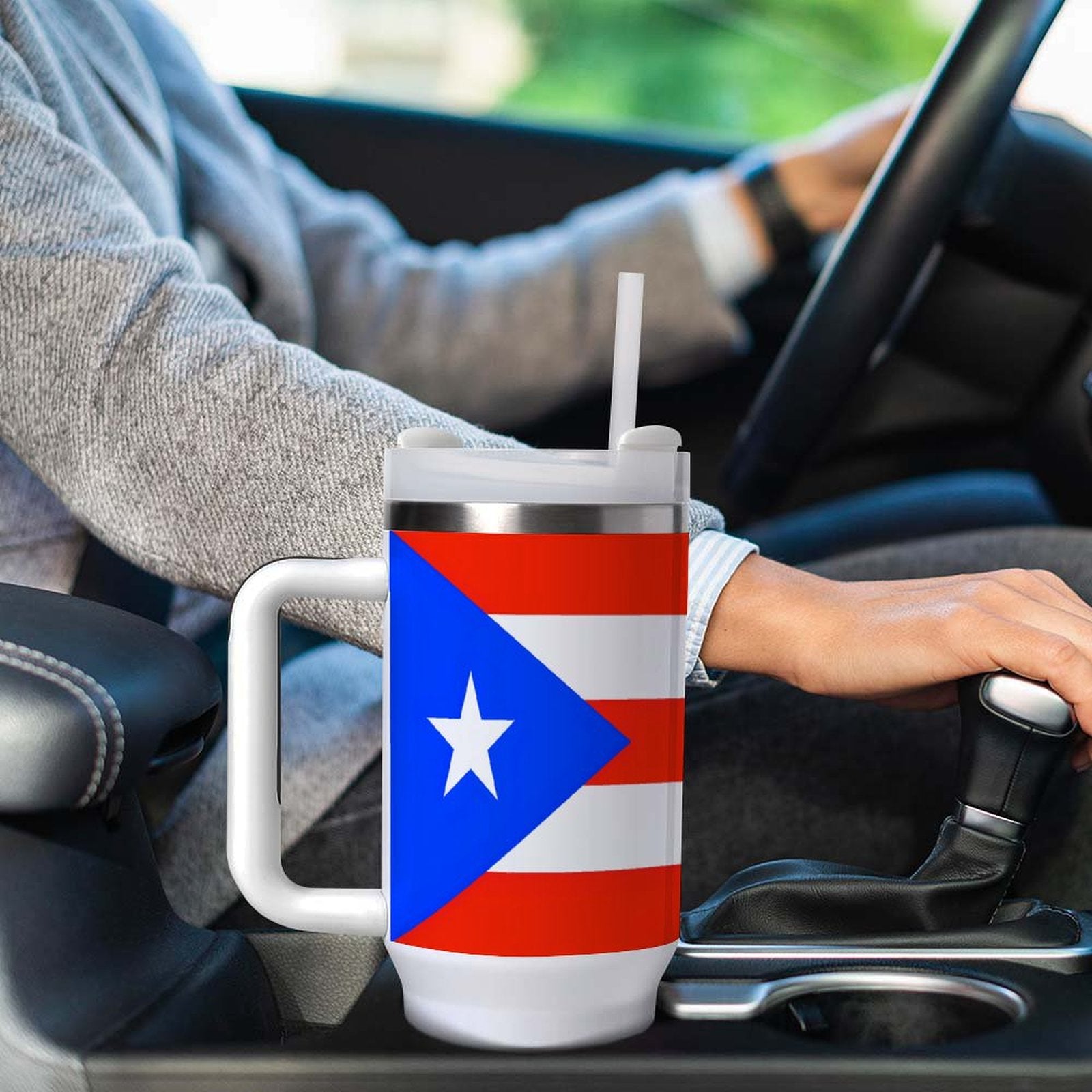 Person driving with [Brand] mug featuring Puerto Rican flag.