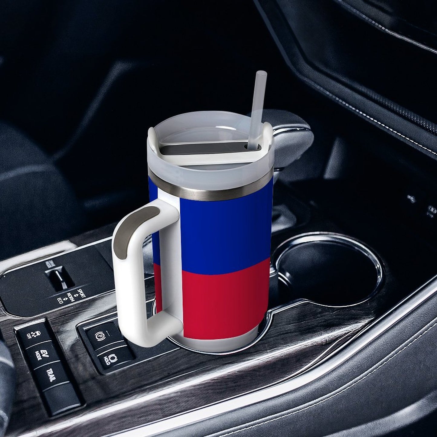 [Brand] travel mug in car's cup holder, featuring handle.