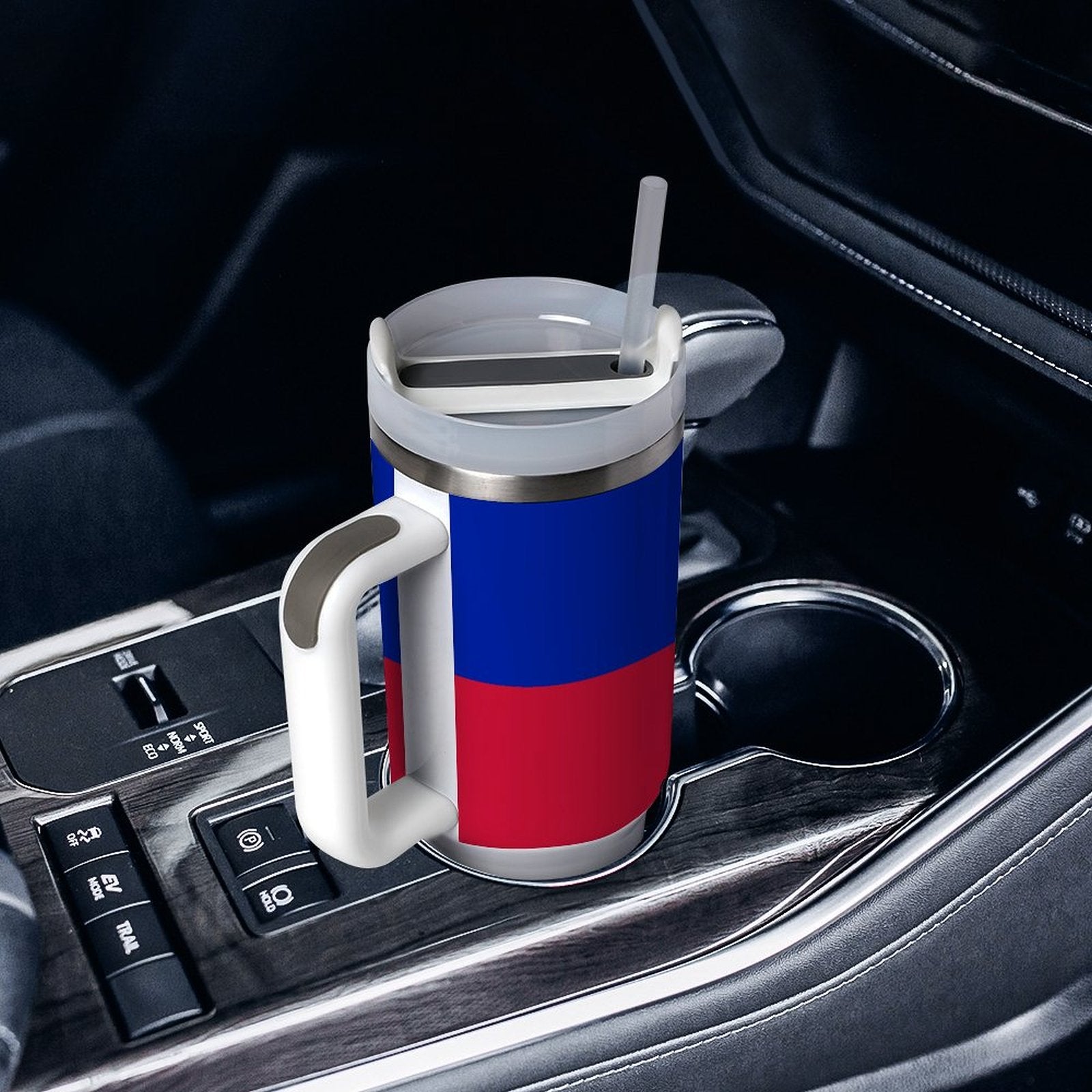 [Brand] travel mug in car's cup holder, featuring handle.
