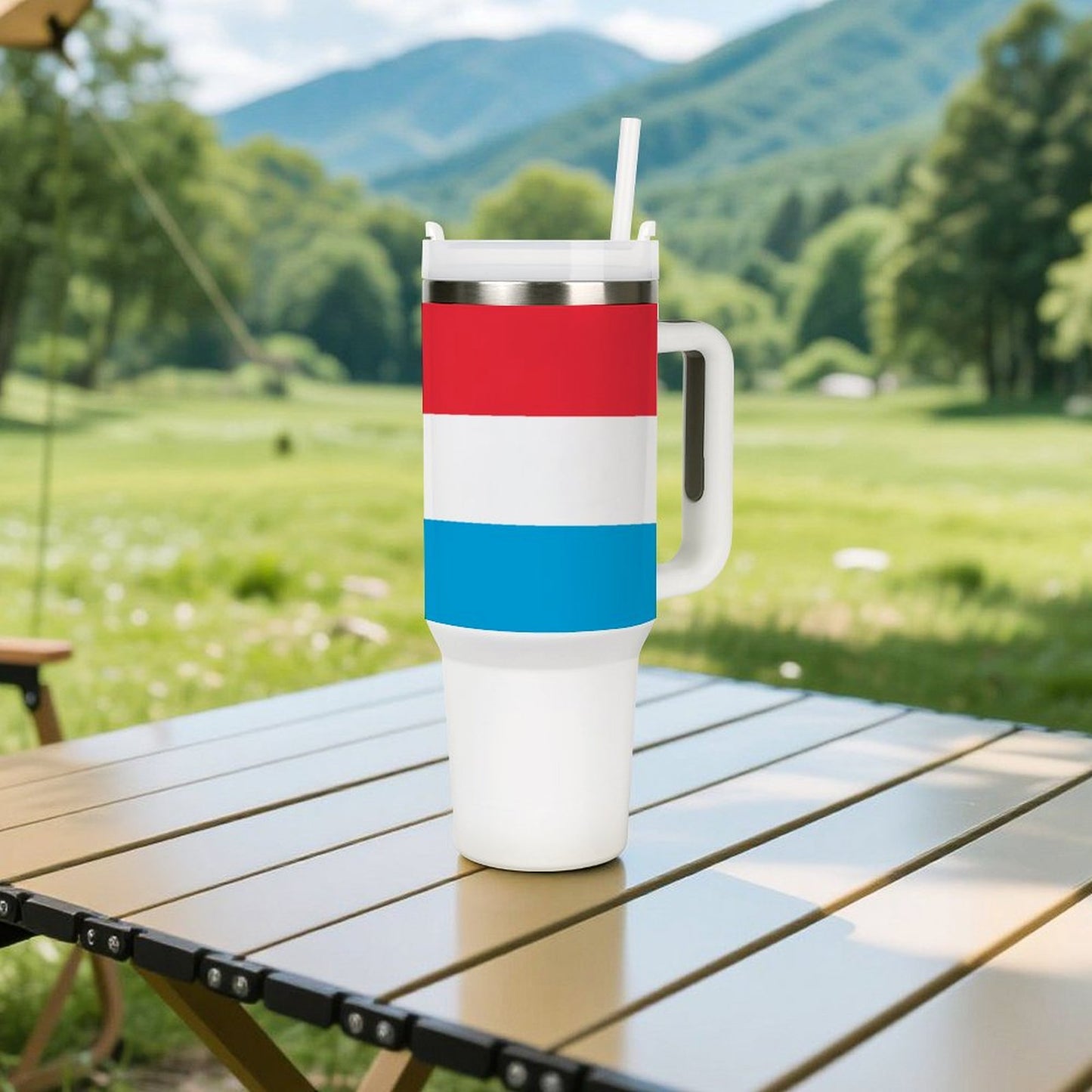 [Brand] tumbler with handle on a wooden picnic table.