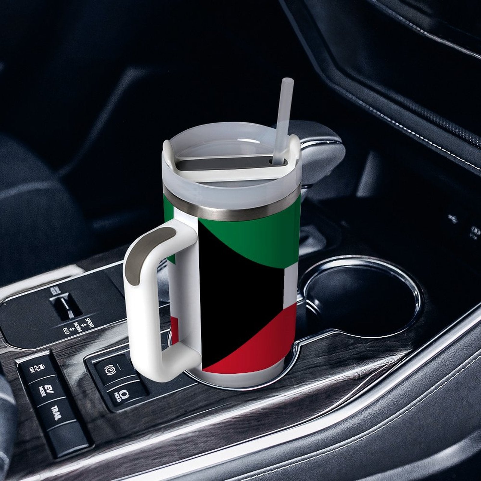 [Brand] travel mug with colorful design in car cupholder.