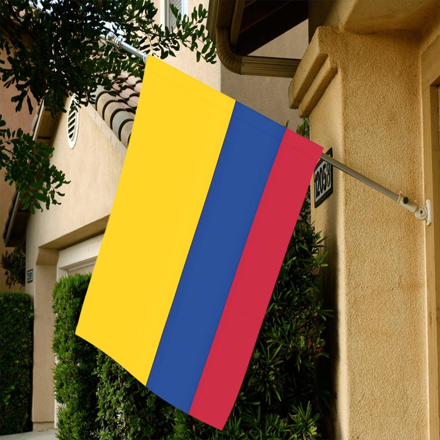 [Luv My Flag] vibrant Colombian flag displayed on house wall.