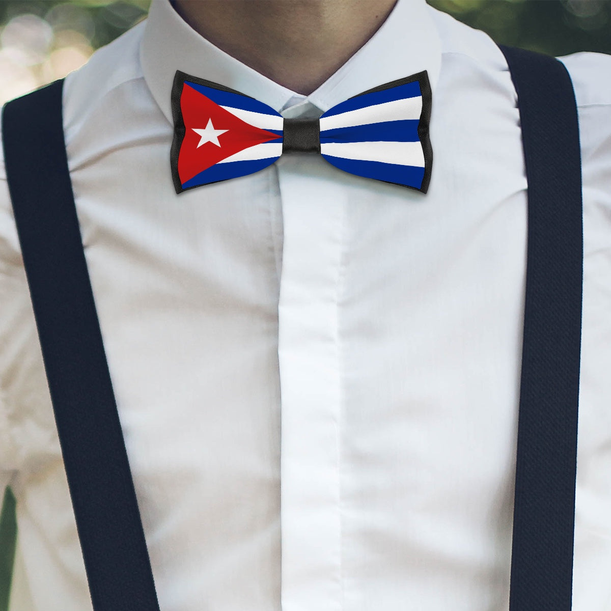 Man wearing [Brand] Cuban flag bow tie and suspenders.