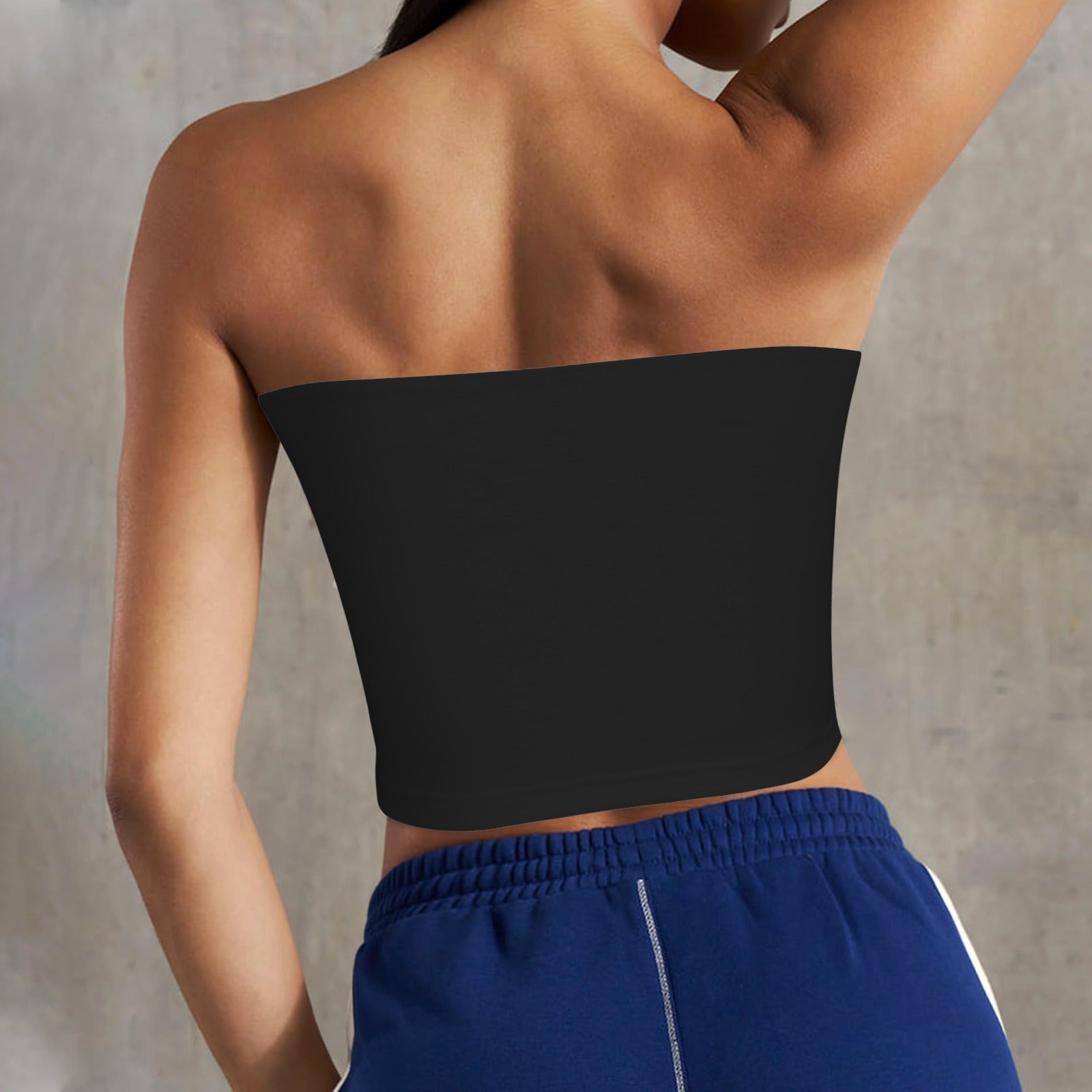 Rear view of woman wearing [Brand] top and shorts.