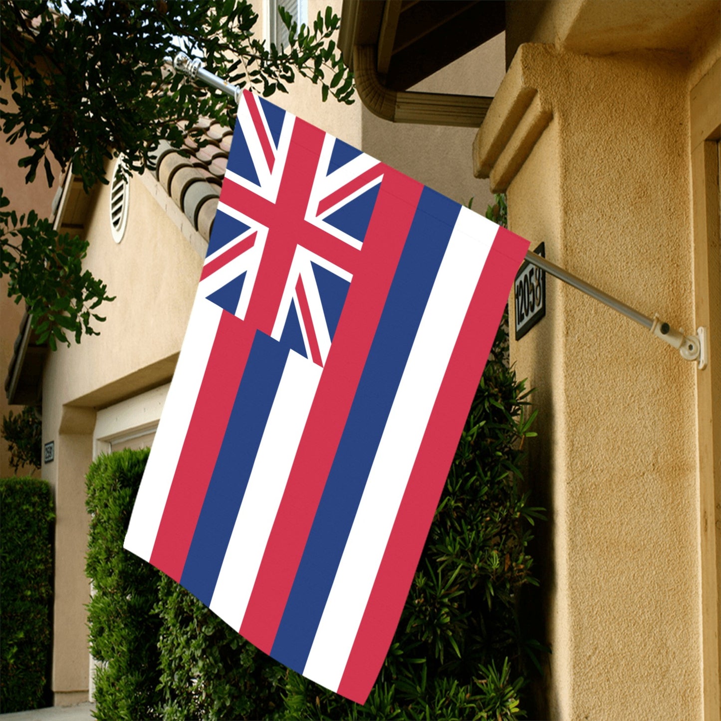 Hawaiian flag displayed outdoors mounted on house. Luv My Flag.