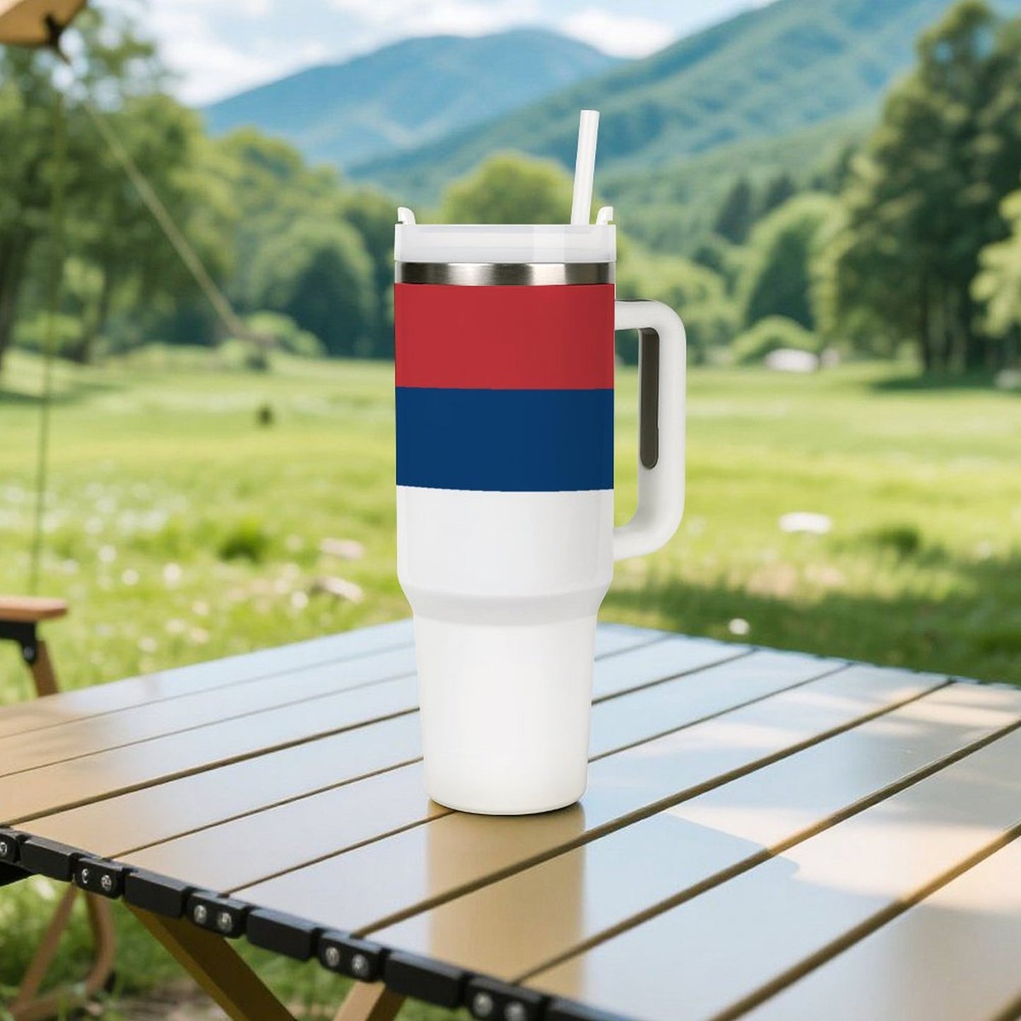 [Brand] tumbler with red, blue stripes on table outdoors.