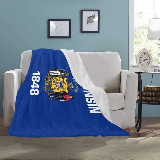 Blue and white Luv My Flag Wisconsin blanket on couch.