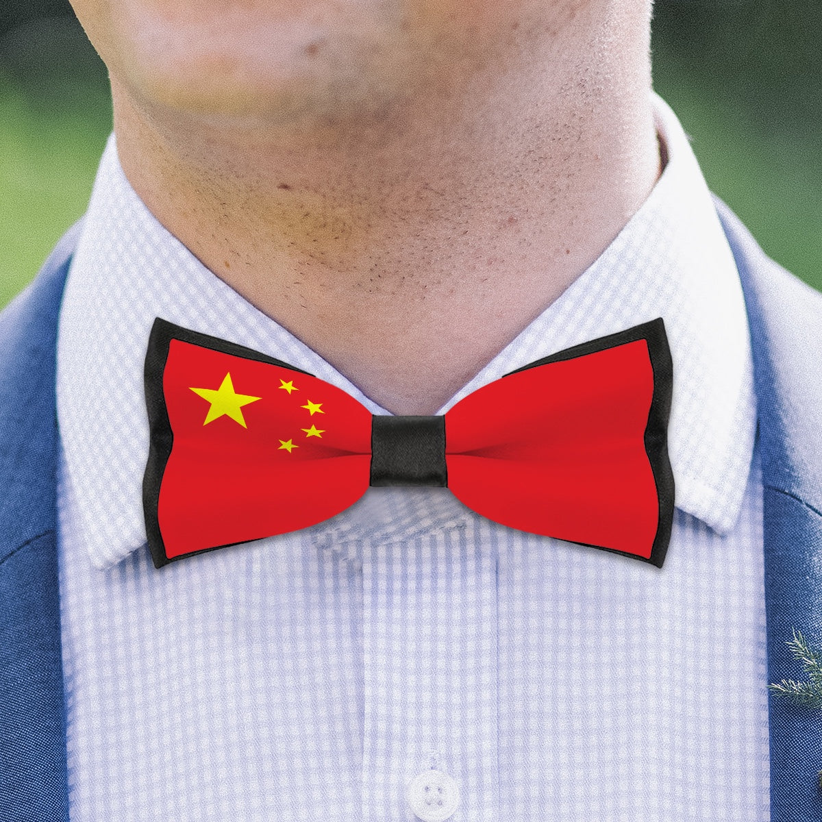 Person wearing [Brand] bow tie featuring China's national flag.