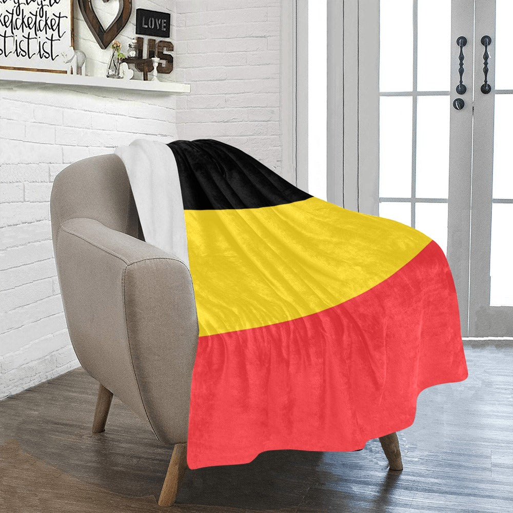 Cozy chair draped with Luv My Flag Belgium blanket.
