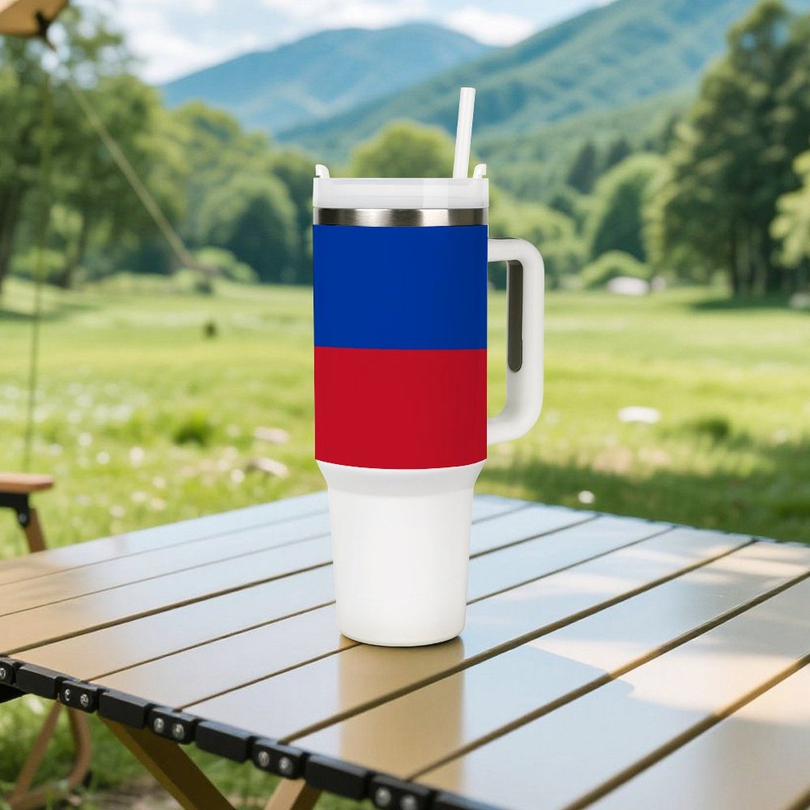 [Brand] tumbler on table, blue and red design, outdoors.