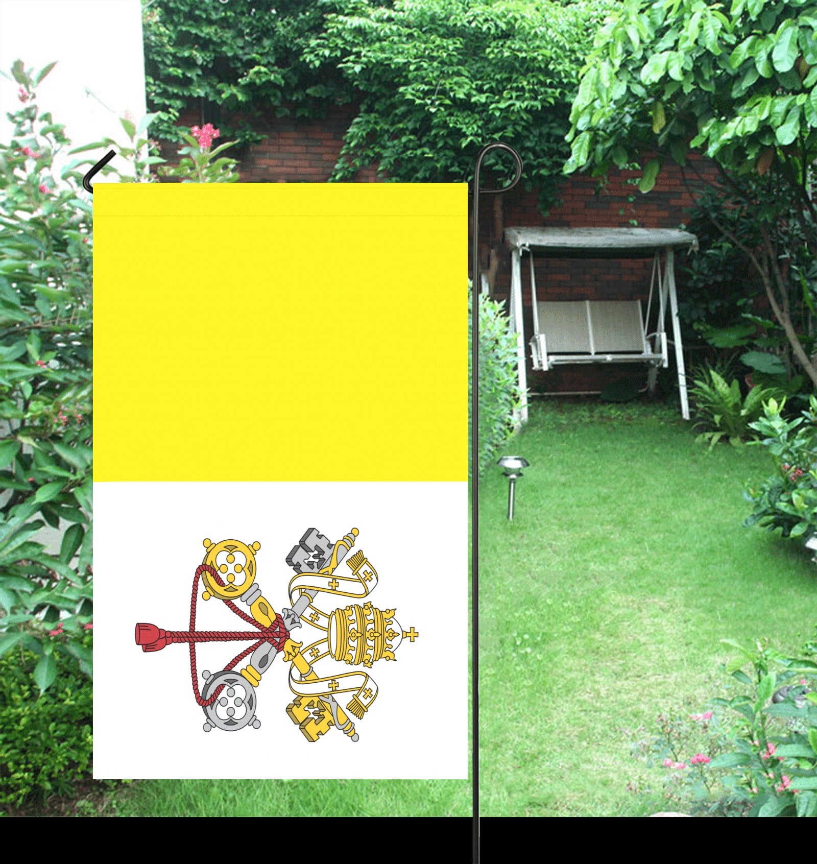 [Luv My Flag] Vatican City garden flag in lush garden.