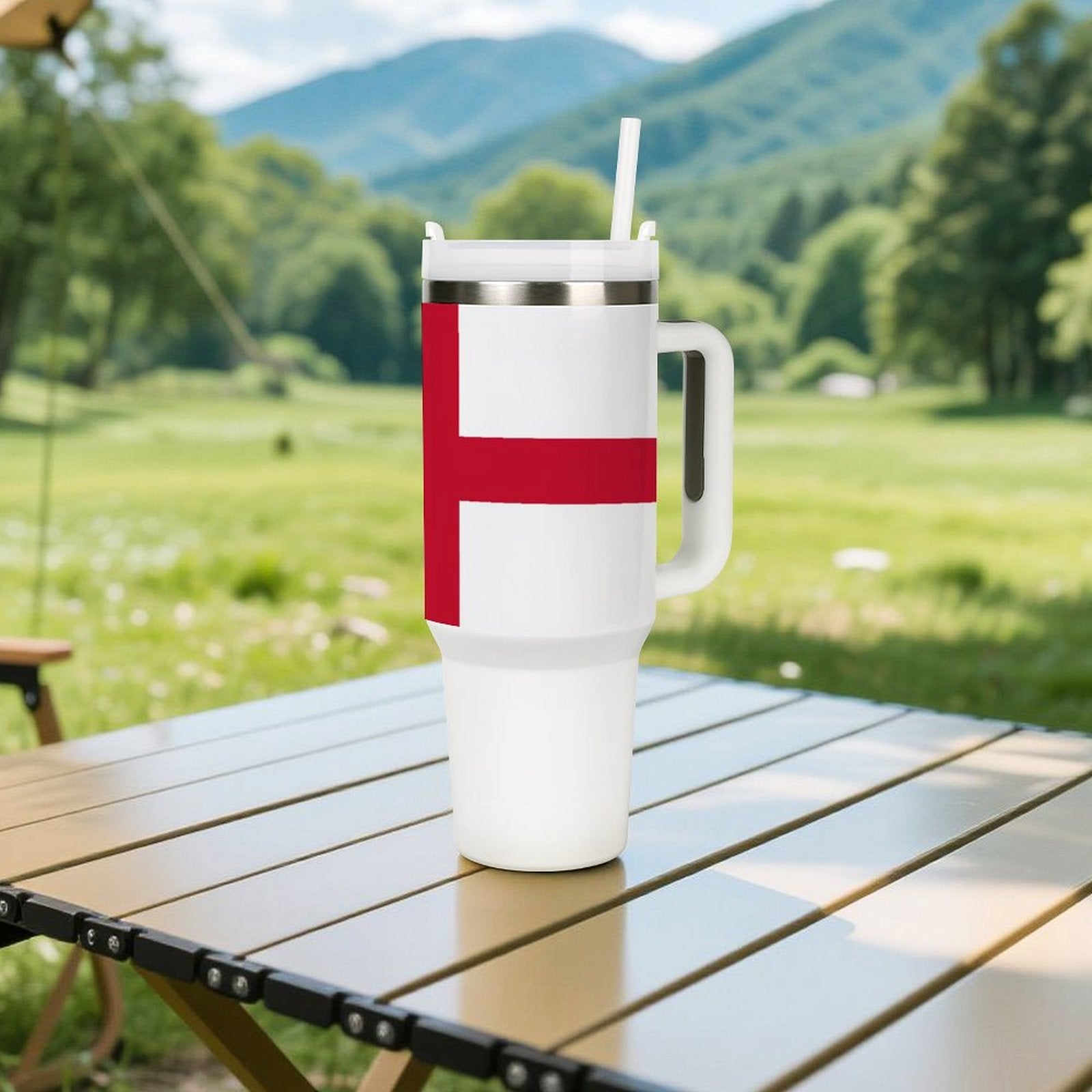 [Brand] tumbler with red cross design on table, outdoors.