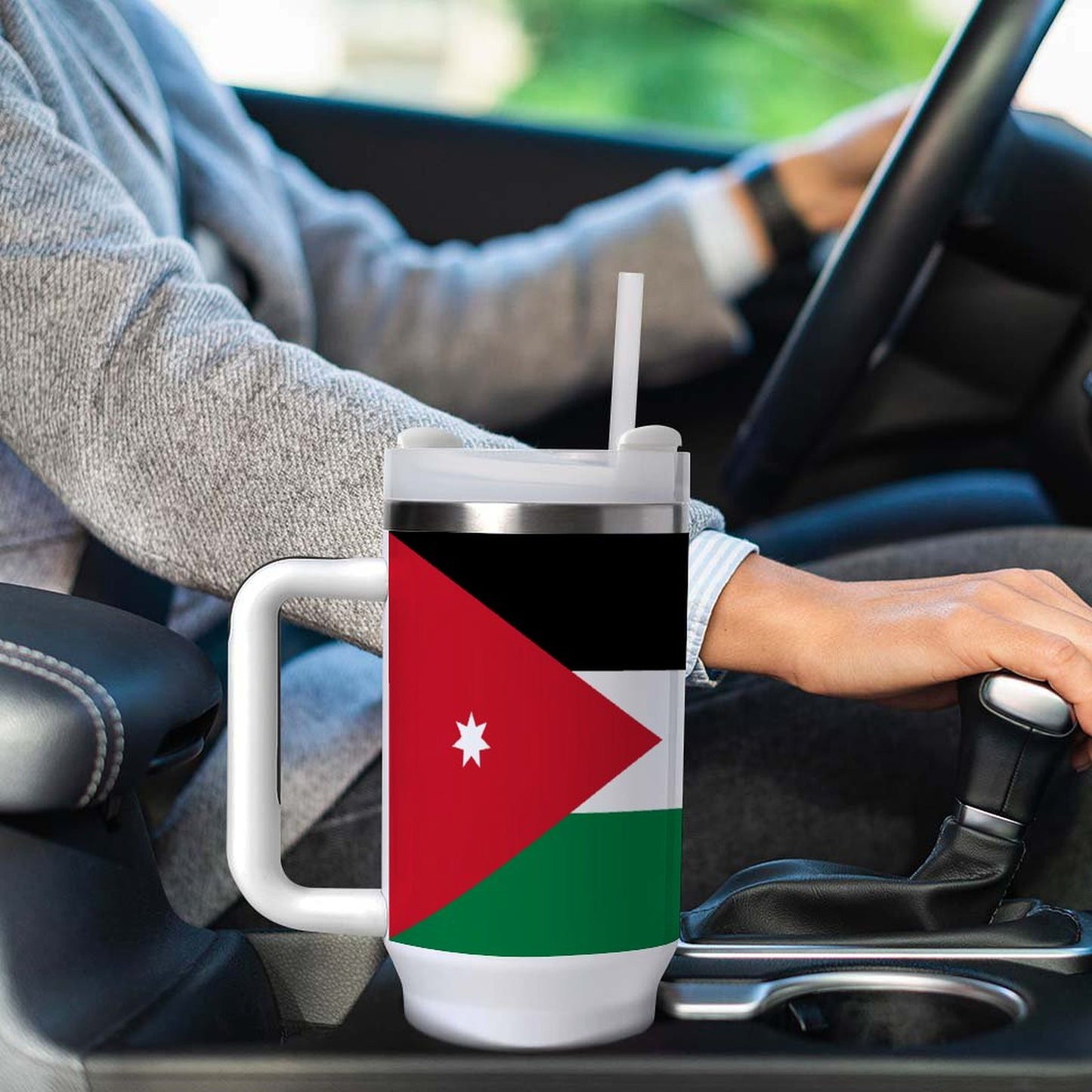 Person driving with [Brand] mug featuring Jordanian flag design.