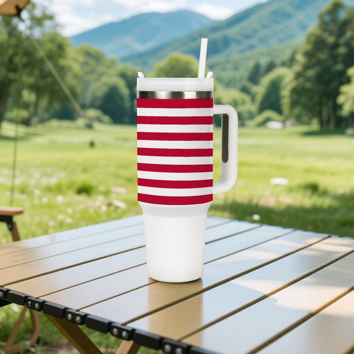 [Brand] striped tumbler with handle on outdoor table setting.
