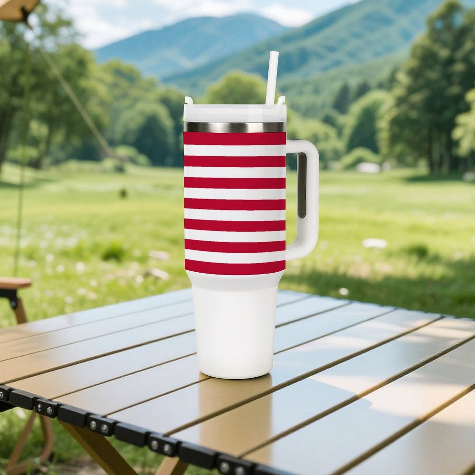 [Brand] striped tumbler with handle on outdoor table setting.