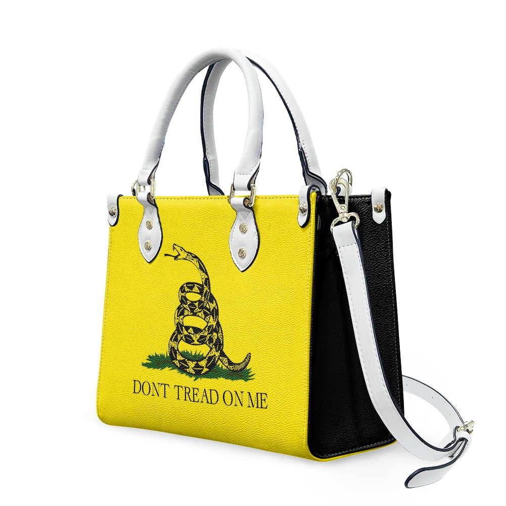 [Brand] handbag, yellow and black with "Don't Tread" design.