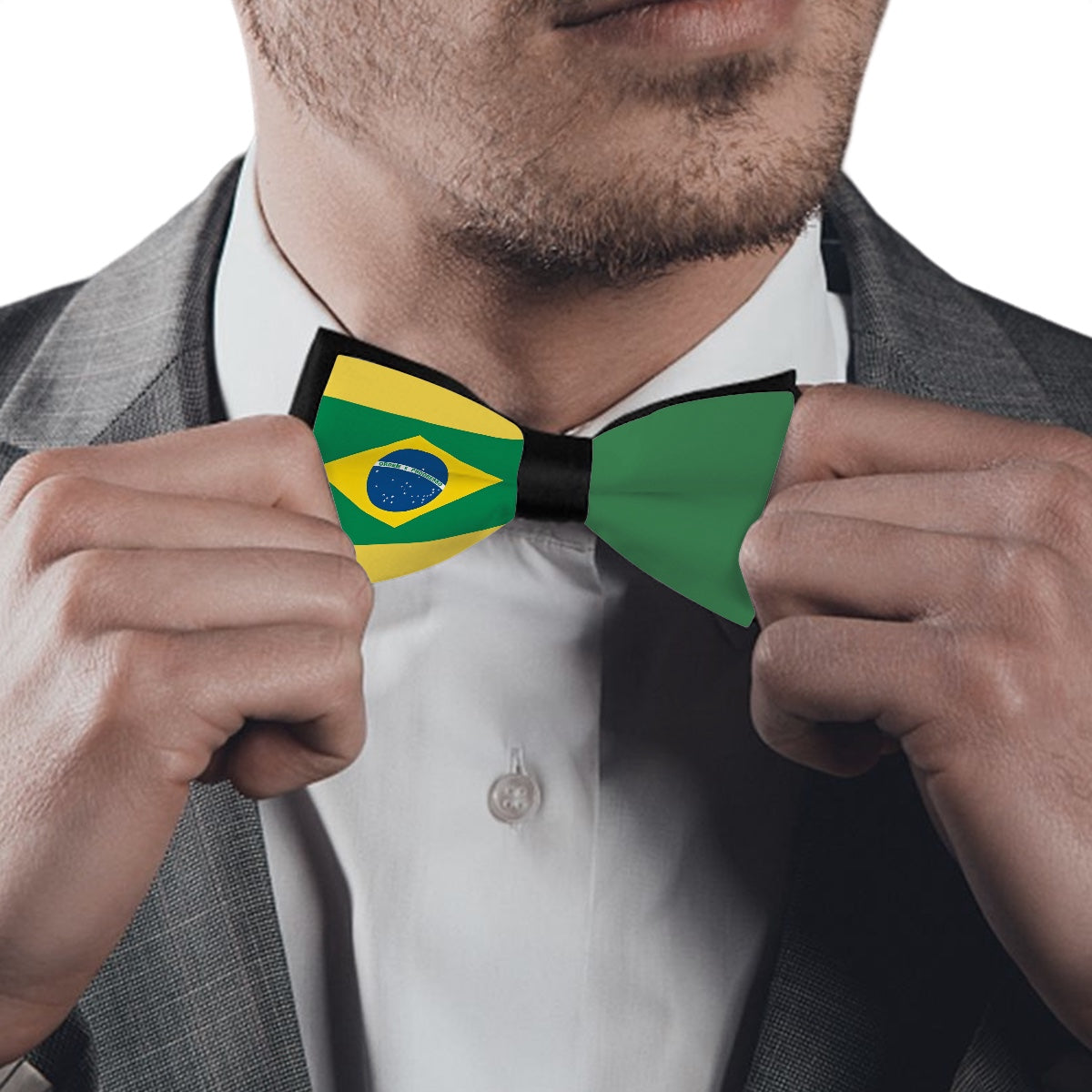 Man adjusting [Brand] Brazil-themed bow tie, wearing suit.