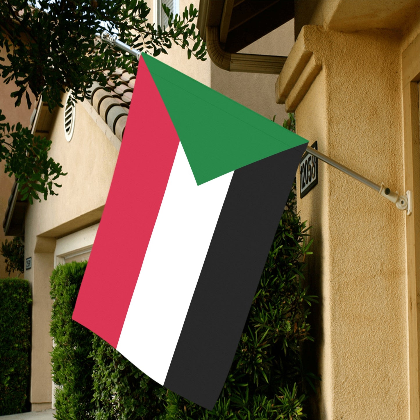 [Luv My Flag] Sudanese flag displayed outside beige house.