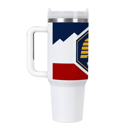 [Brand] white travel mug with colorful geometric design, handle.