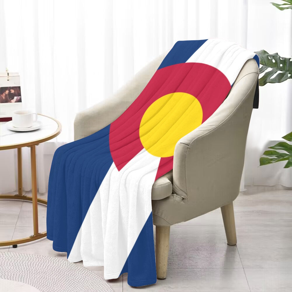 Cozy chair draped with a Luv My Flag blanket.