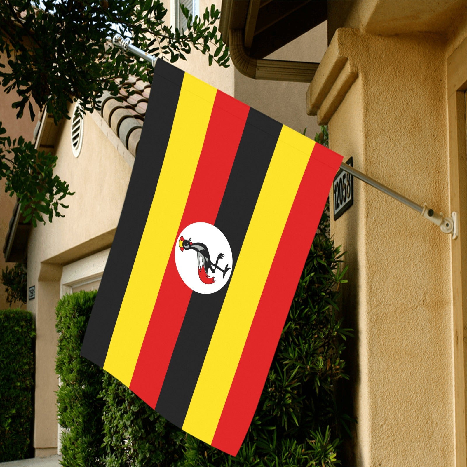 House with [Luv My Flag] Uganda flag on display.