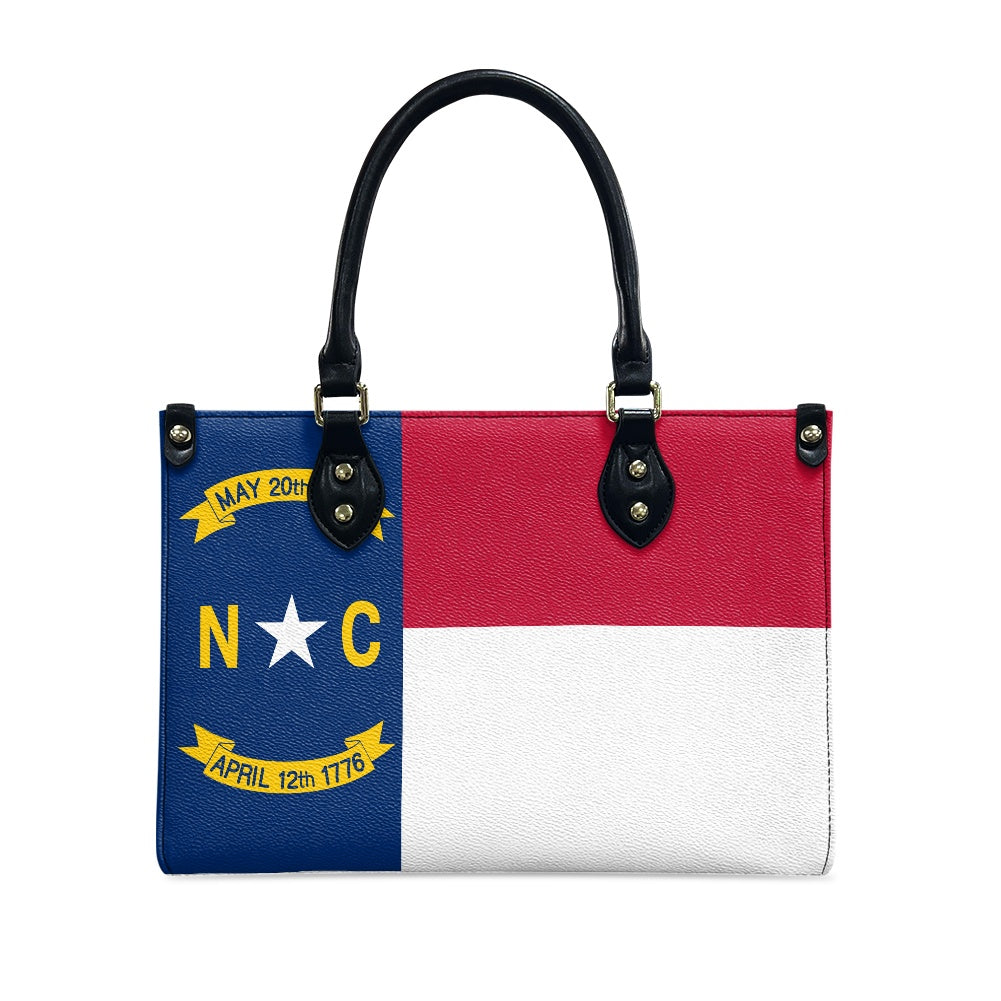 [Brand] handbag featuring the North Carolina state flag design.