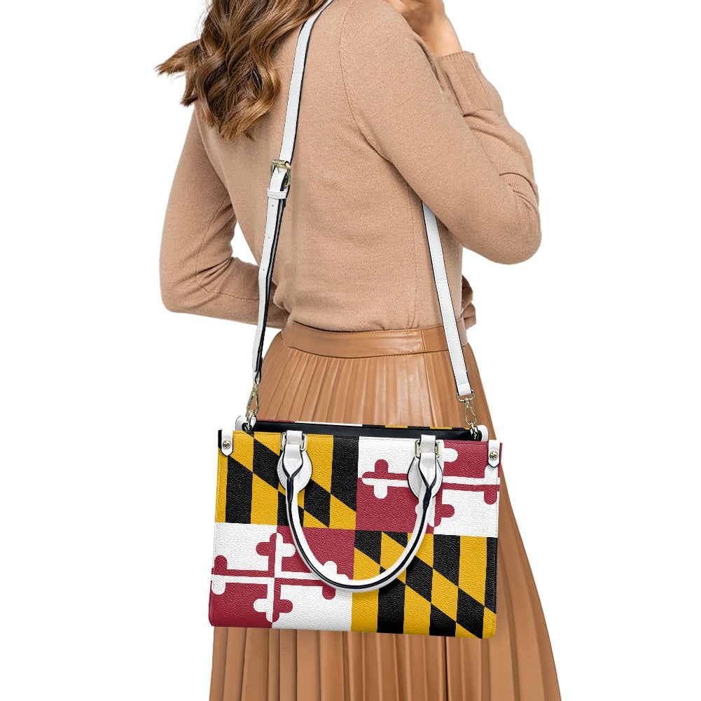 Back view woman with [Brand] Maryland flag handbag, wearing beige.