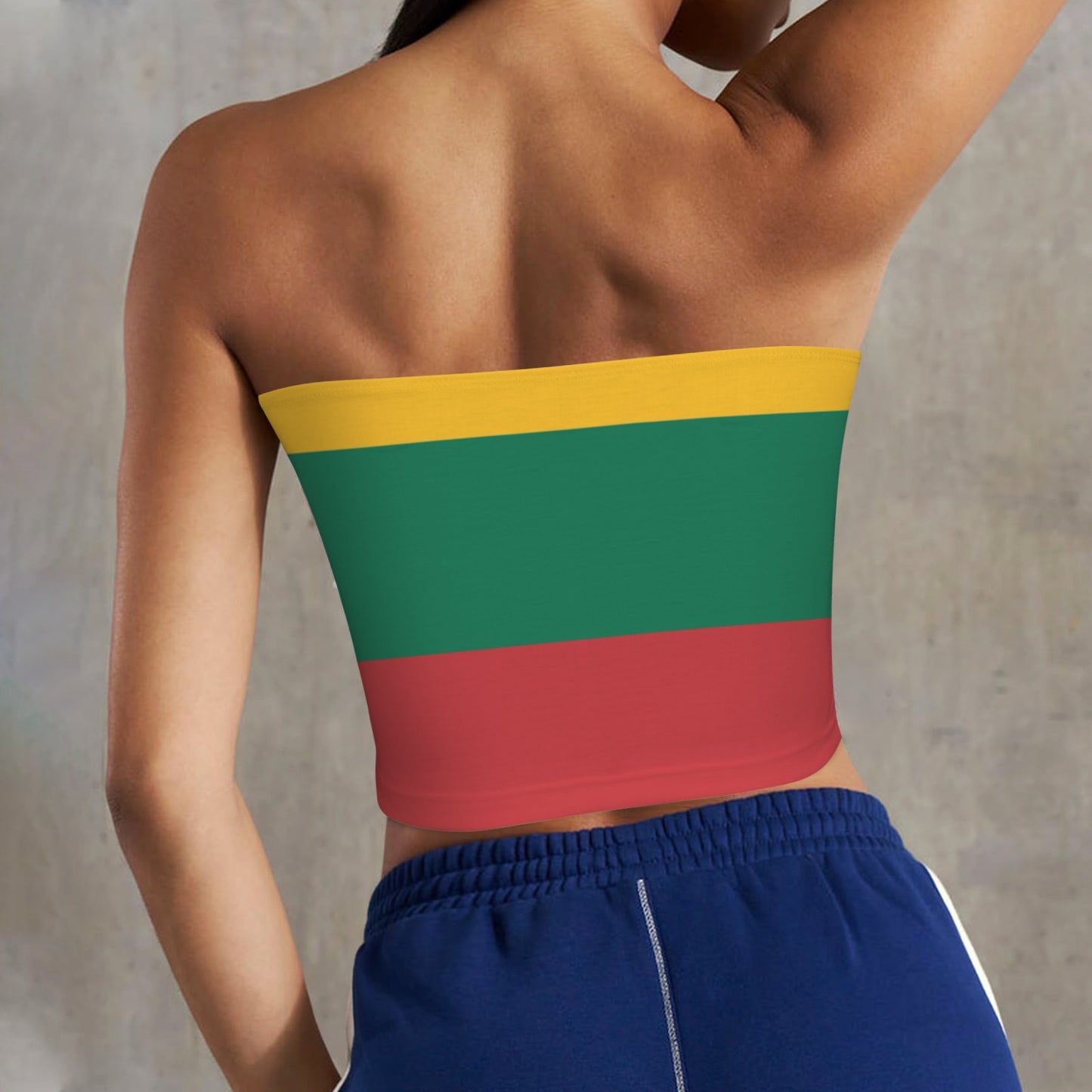 Woman wearing [Brand] colorful tube top and blue shorts.