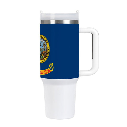 [Brand] travel mug featuring Idaho state seal design, blue background.