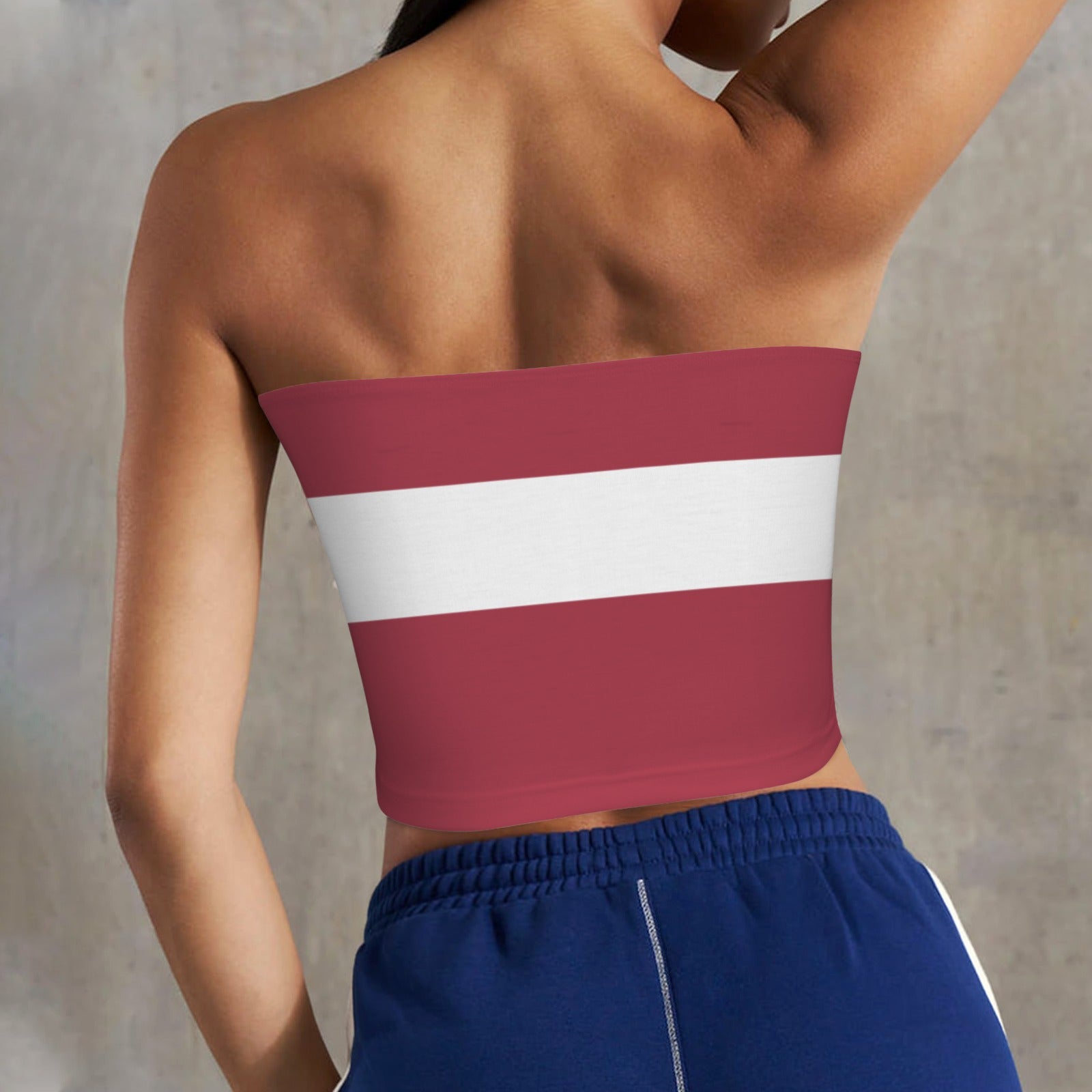 Rear view of person in striped top, blue pants. [Brand]