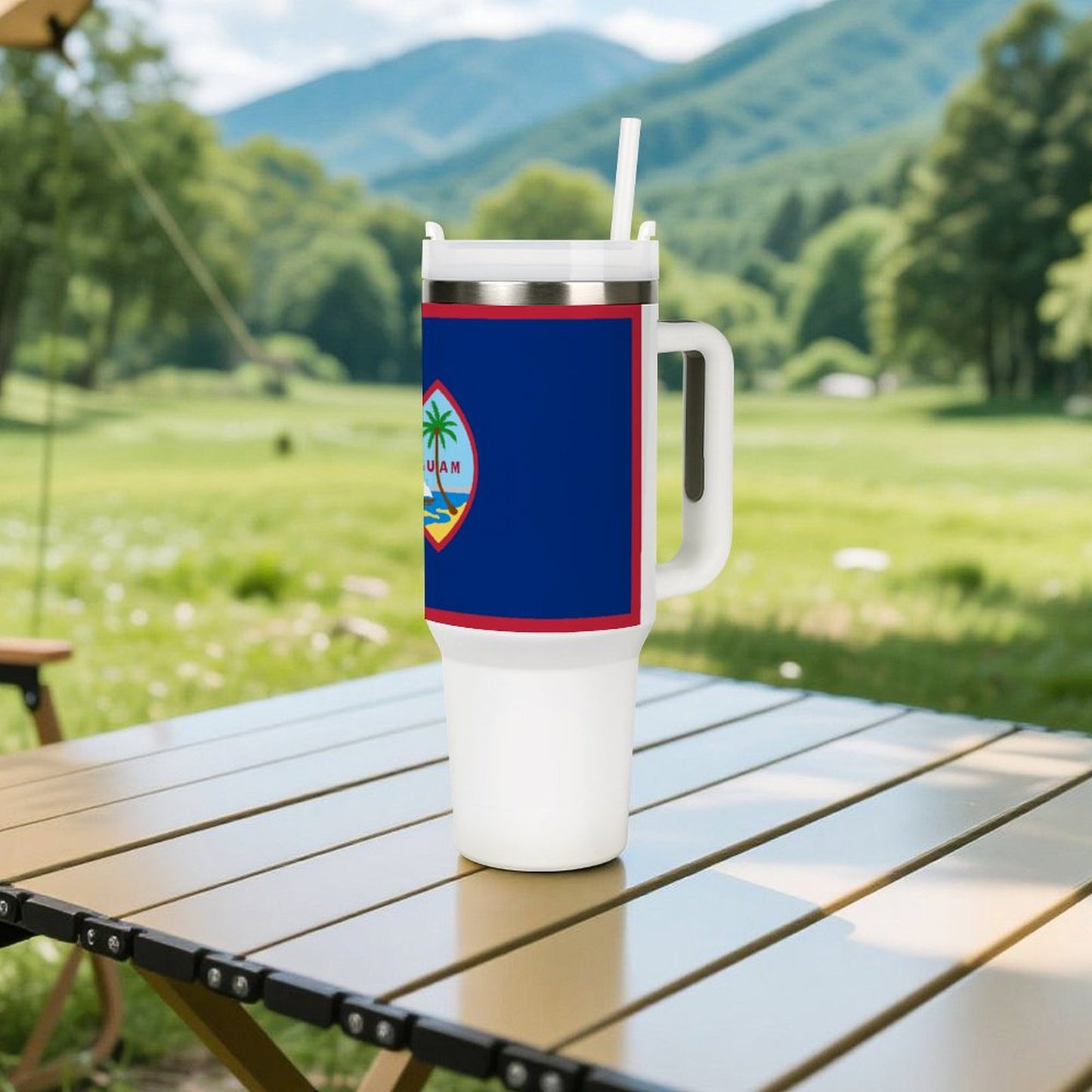 A [Brand] tumbler on a table, mountains in background.