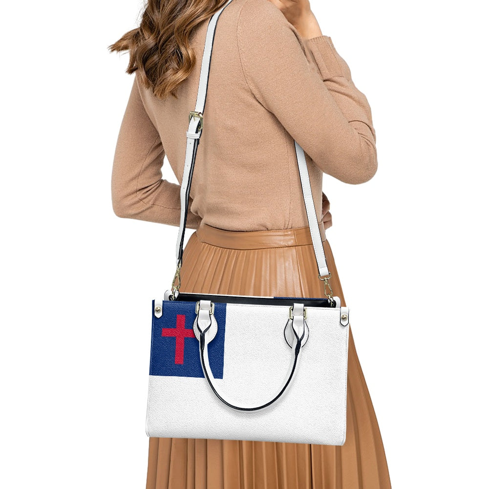 Woman carrying [Brand] handbag with cross flag design.