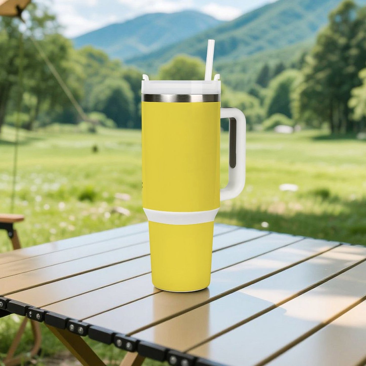 Yellow [Brand] tumbler with straw on outdoor table, scenic background.
