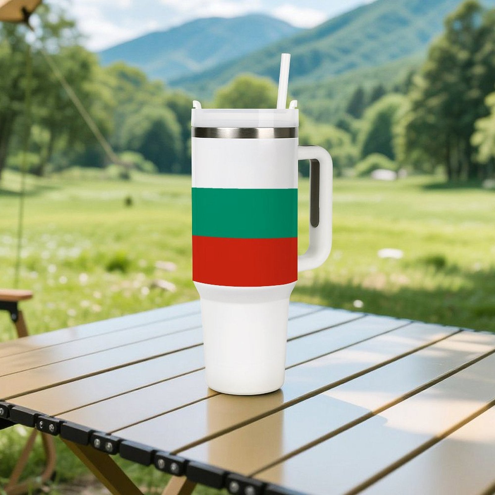 [Brand] tumbler with straw on outdoor table, scenic background.