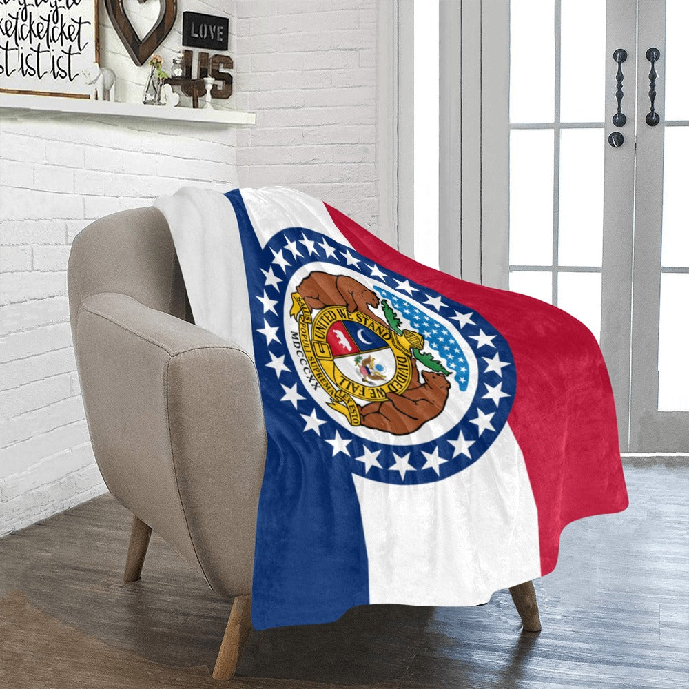 [Luv My Flag] Missouri-themed blanket draped over beige chair.