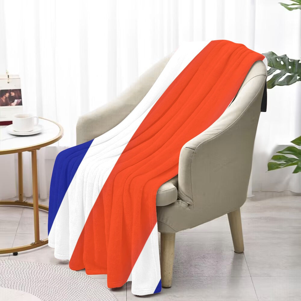 Luv My Flag blanket draped over chair, colorful stripes.