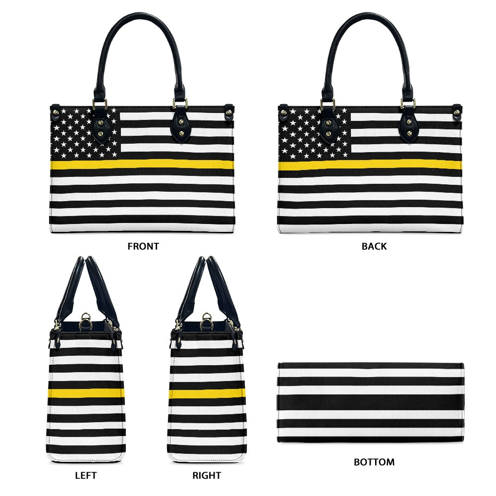 [Brand] handbag with black, white stripes, and yellow accents.