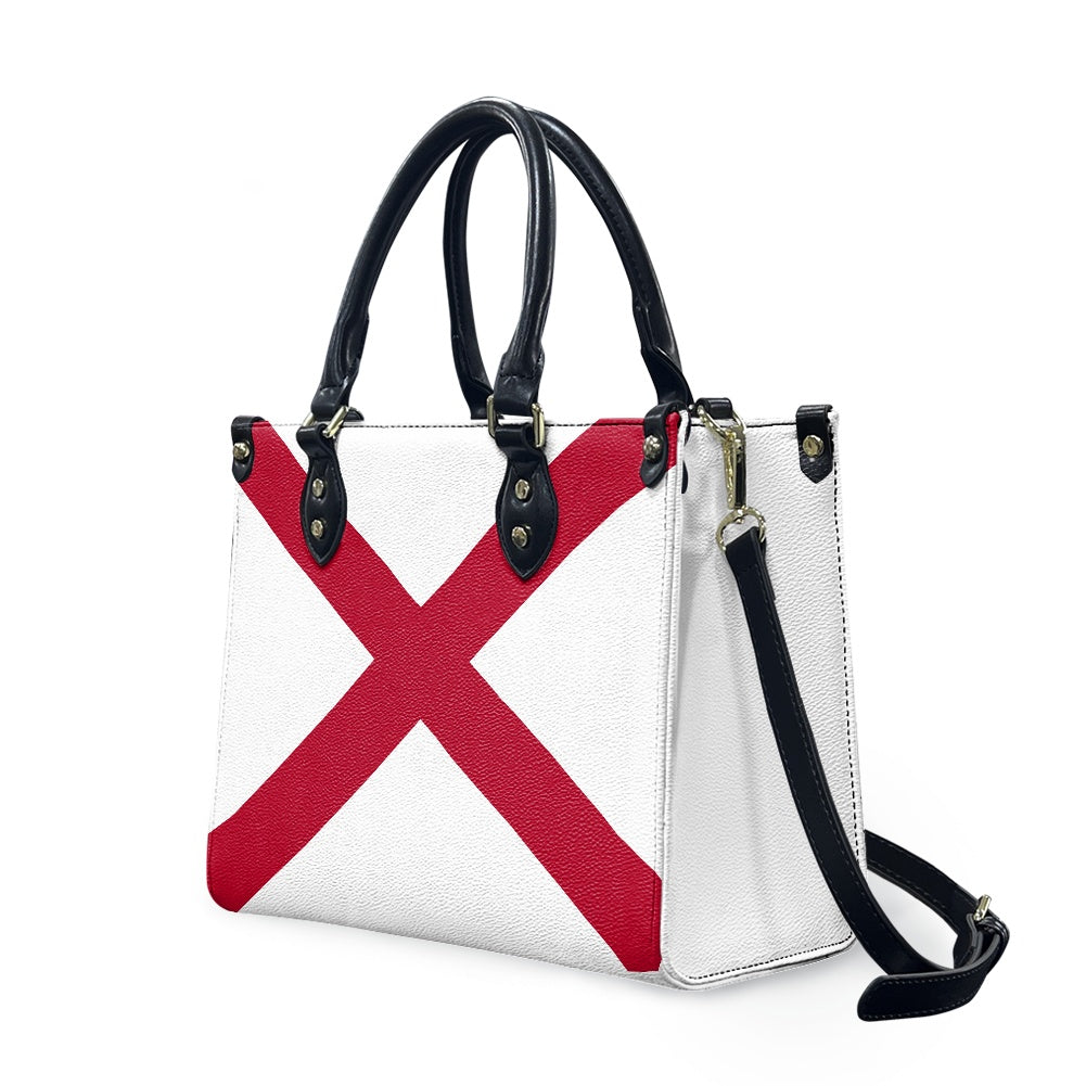 [Brand] handbag with red cross design, black handles, strap.