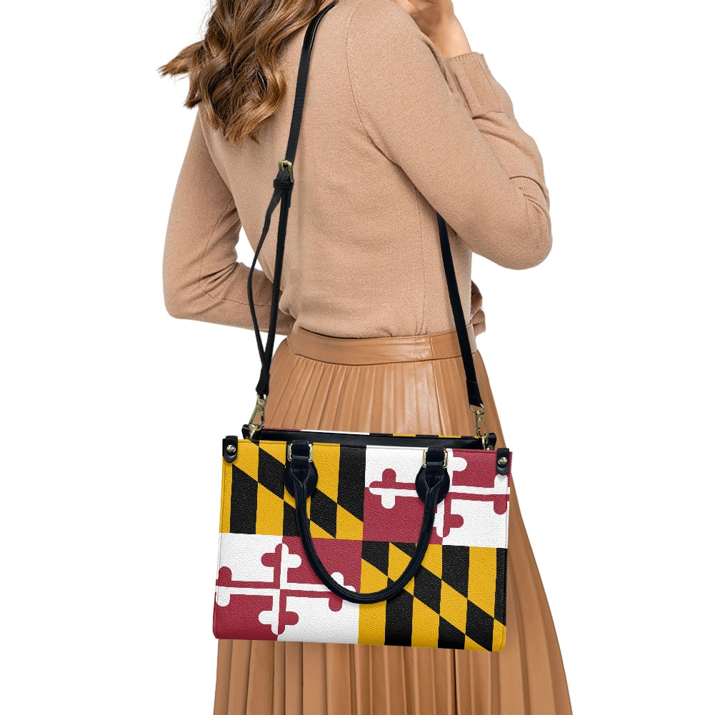 Woman carrying [Brand] handbag with Maryland flag design.