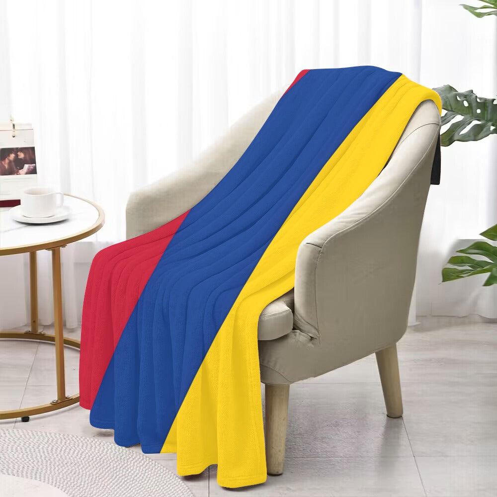 Comfortable chair draped with Luv My Flag colorful blanket.