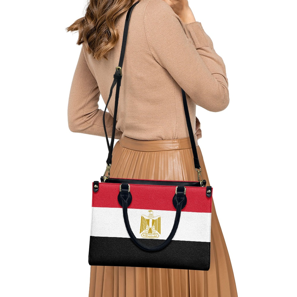 Woman carrying [Brand] handbag featuring Egypt flag design.