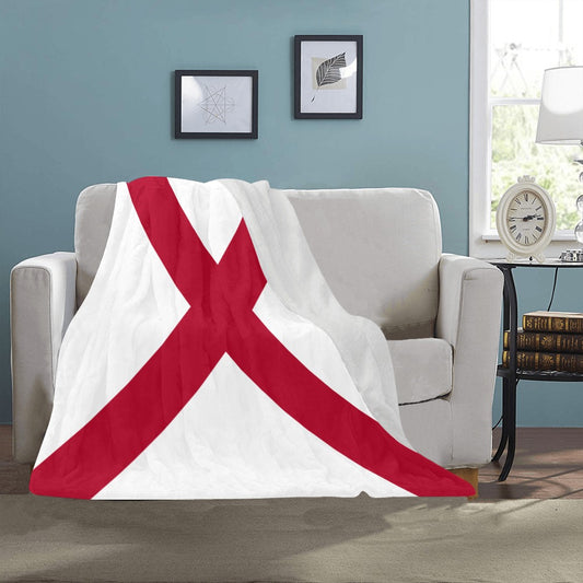 Cozy sofa with [Luv My Flag] blanket featuring red cross.