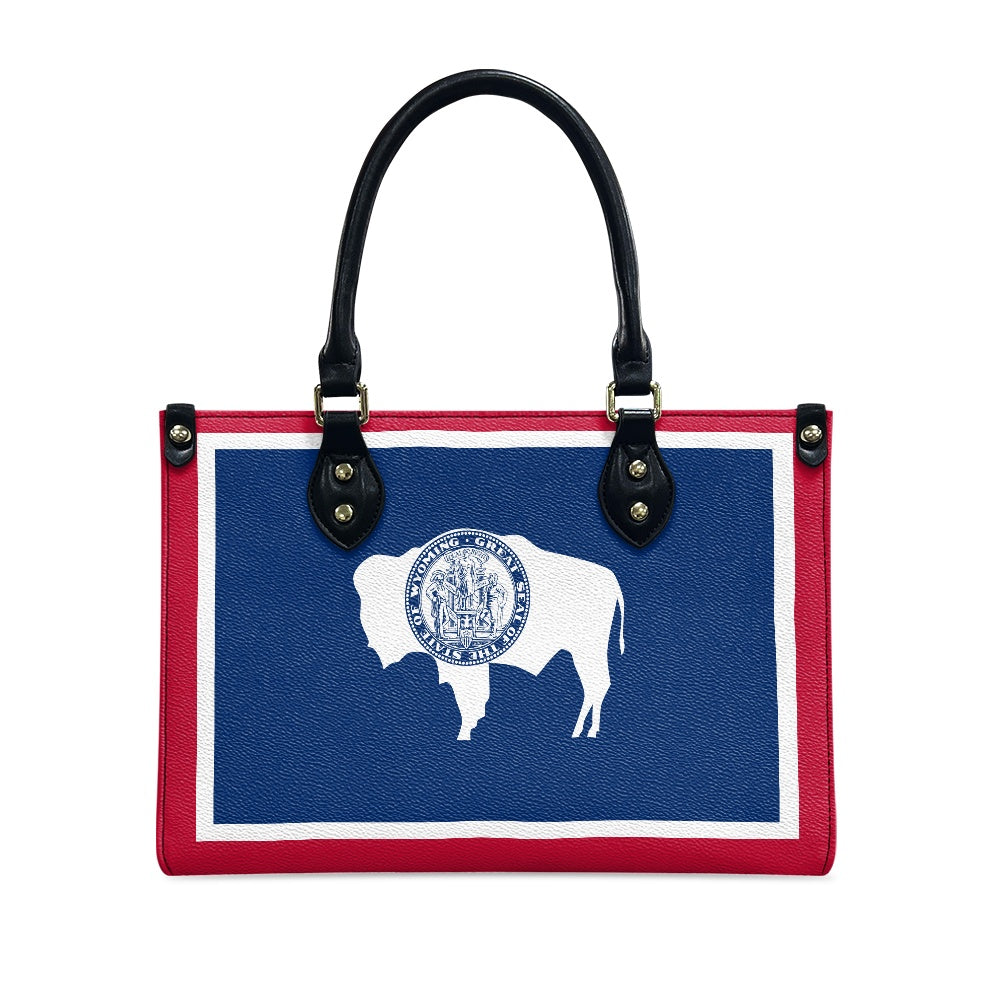 [Brand] handbag featuring Wyoming flag design with buffalo silhouette.